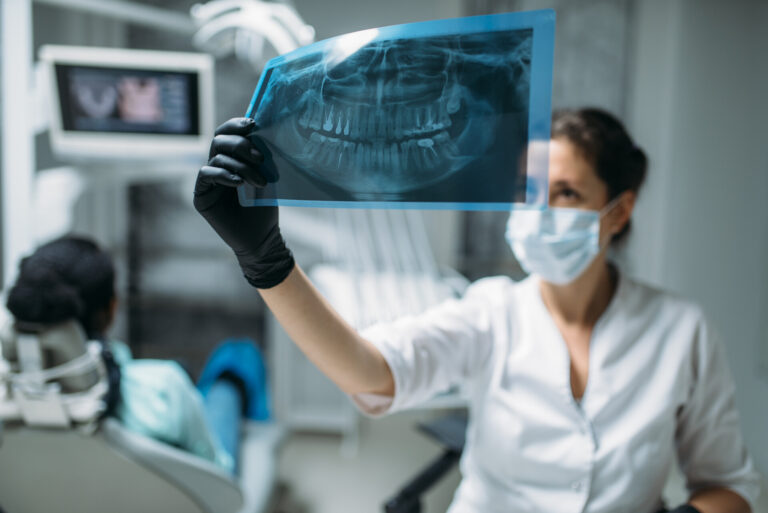 female dentist looking x ray