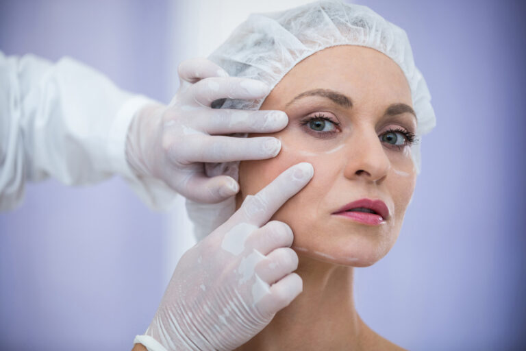 doctor examining female patients face cosmetic treatment